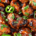Grilled jalapeno chicken garnished with cilantro and jalapeno slices.