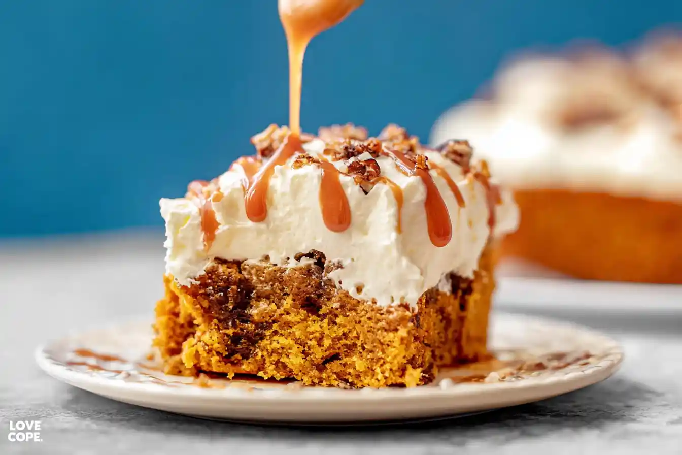 A deliciously moist Pumpkin Poke Cake topped with a generous layer of creamy white frosting and a sprinkle of cinnamon, ready to be served.