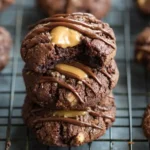 A stack of three {{ $('Fetch Recipe Data').first().json["Main Keyword"] }} drizzled with melted chocolate on a cooling rack.