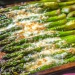 Pan of freshly made {{ $('Fetch Recipe Data').first().json["Main Keyword"] }} with melted cheese and lemon.