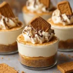 Close-up of layered {{ $('Fetch Recipe Data').first().json["Main Keyword"] }} topped with whipped cream and a spiced cookie.