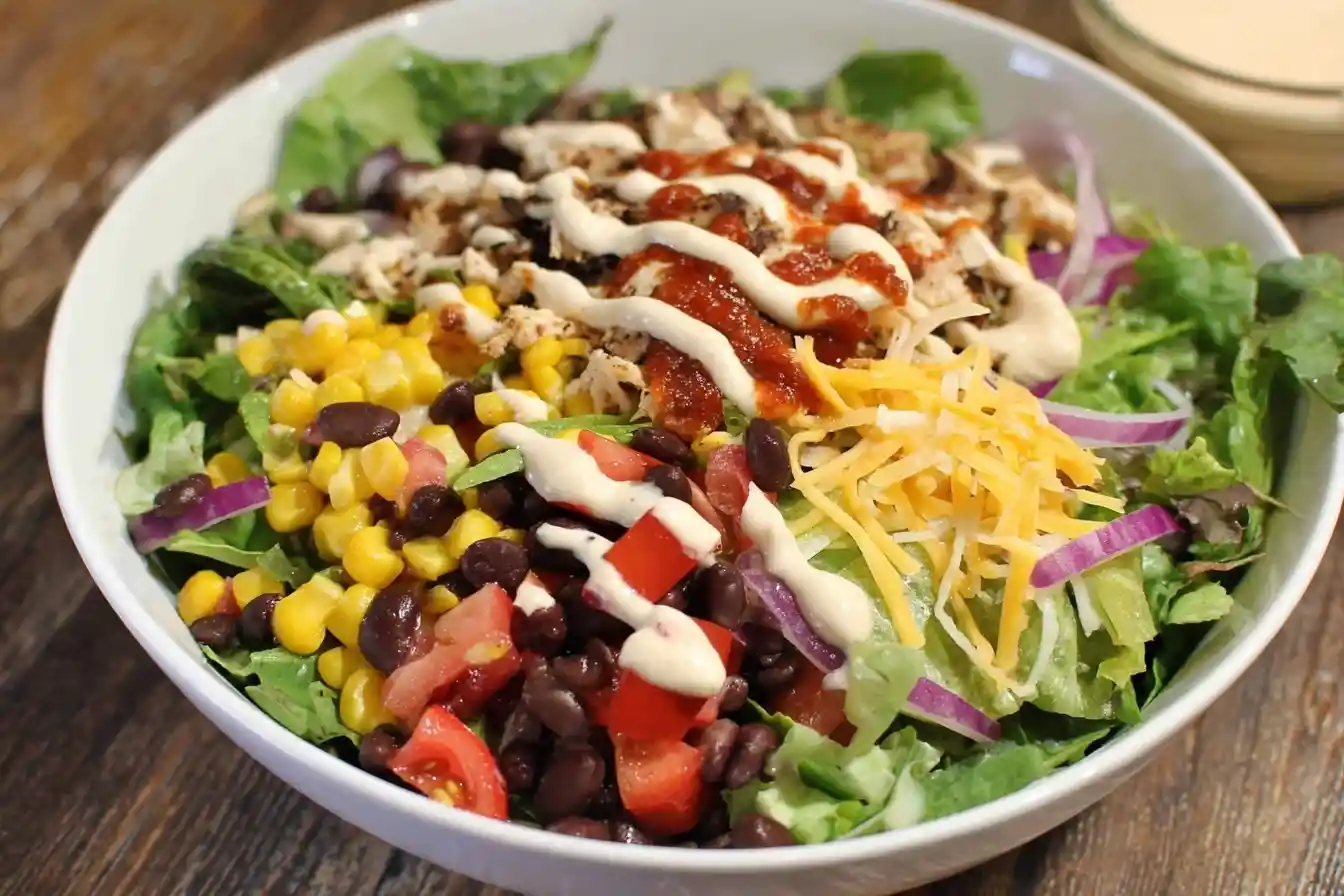 Fresh {{ $('Fetch Recipe Data').first().json["Main Keyword"] }} in a bowl with corn and black beans.