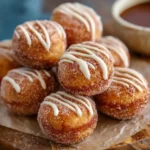 Close-up of stacked {{ $('Fetch Recipe Data').first().json["Main Keyword"] }} rolled in cinnamon sugar with a sweet white glaze drizzle.