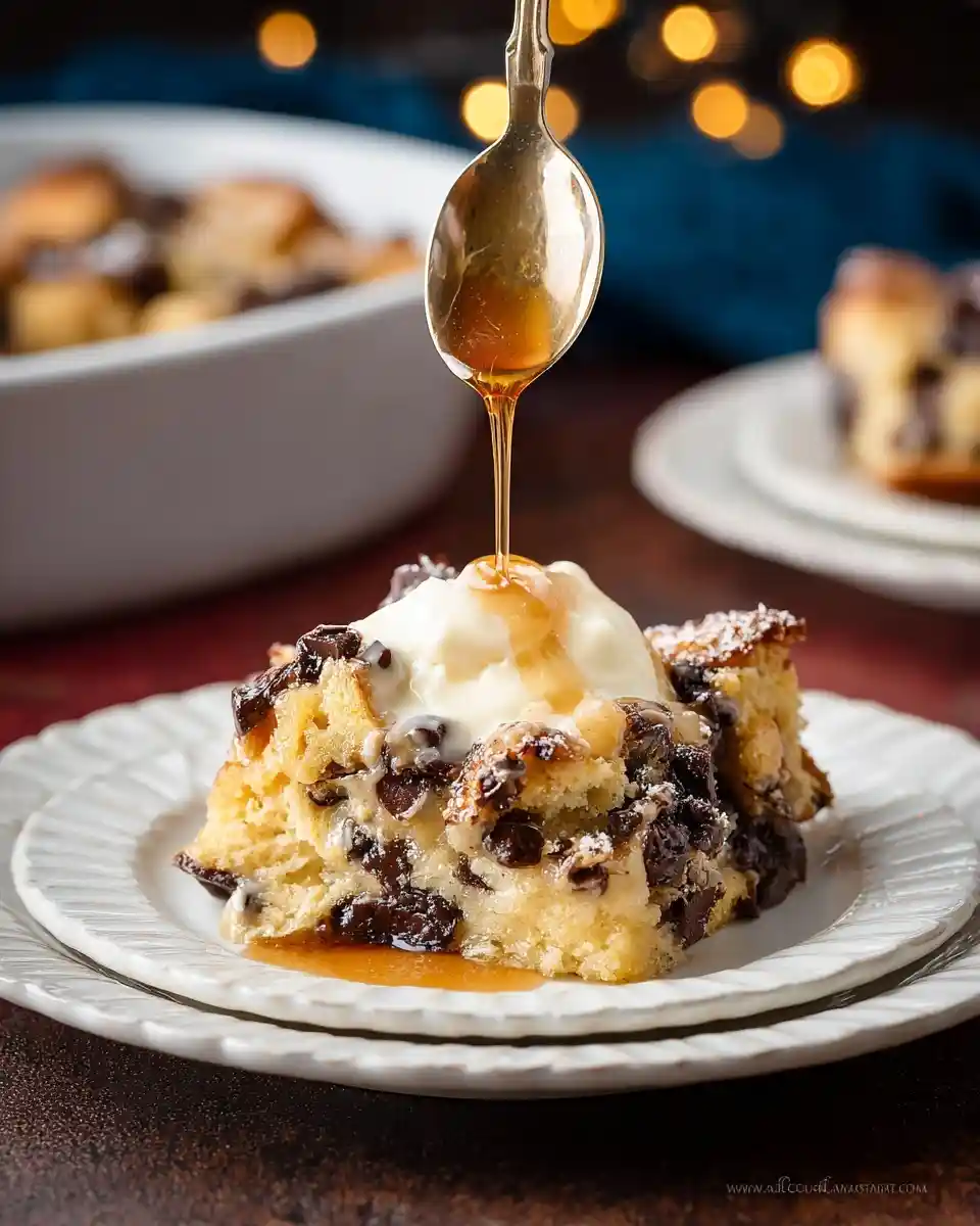 Pouring syrup over a warm slice of chocolate chip bread pudding topped with vanilla ice cream.