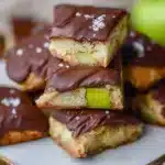 Chocolate dipped blondies with green apple topping on a plate