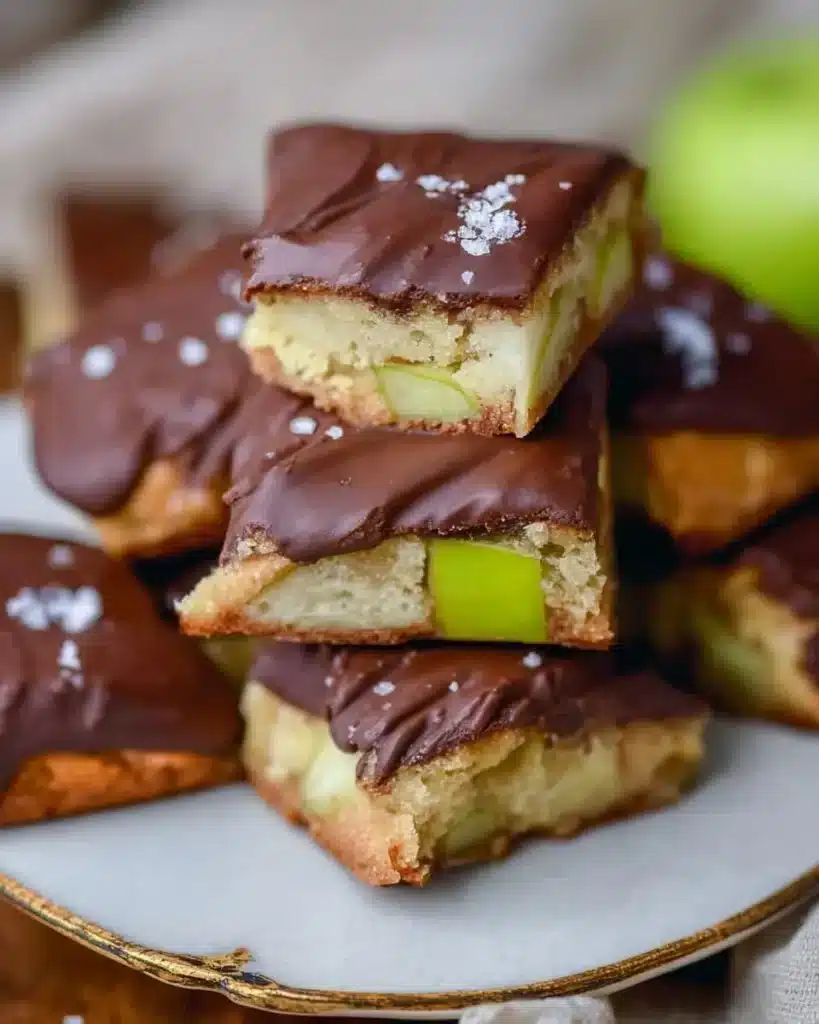 Chocolate dipped blondies with green apple topping on a plate