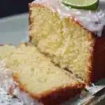 Coconut Lime Margarita Pound Cake drizzled with lime glaze and coconut flakes