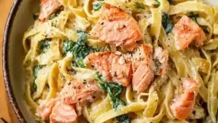 Creamy lemon-dill salmon fettuccine Alfredo served on a white plate