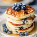 Healthy Greek yogurt blueberry pancakes stacked on a plate