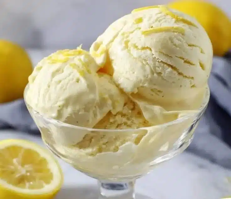 Creamy limoncello ice cream in a bowl with a lemon garnish