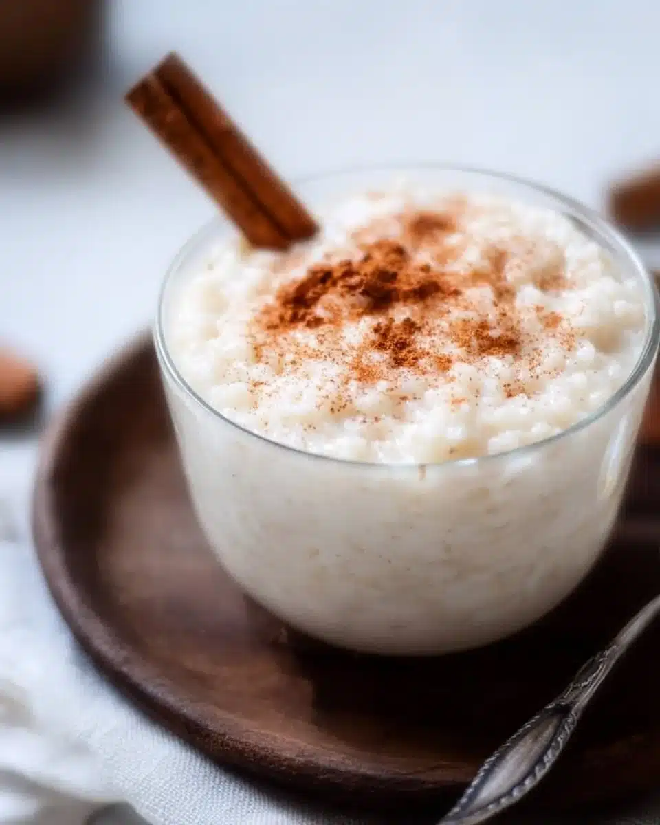 Bowl of creamy Mexican Rice Pudding topped with cinnamon and raisins