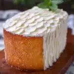 Moist vanilla cake with smooth frosting and decorative sprinkles.