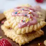Homemade Raspberry Pop Tart Cookies with icing and raspberry filling