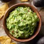 Delicious single serving of homemade guacamole with fresh avocados and spices.